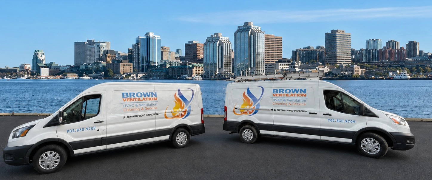 Brown Ventilation LTD service vans on the Dartmouth waterfront with the Halifax skyline behind